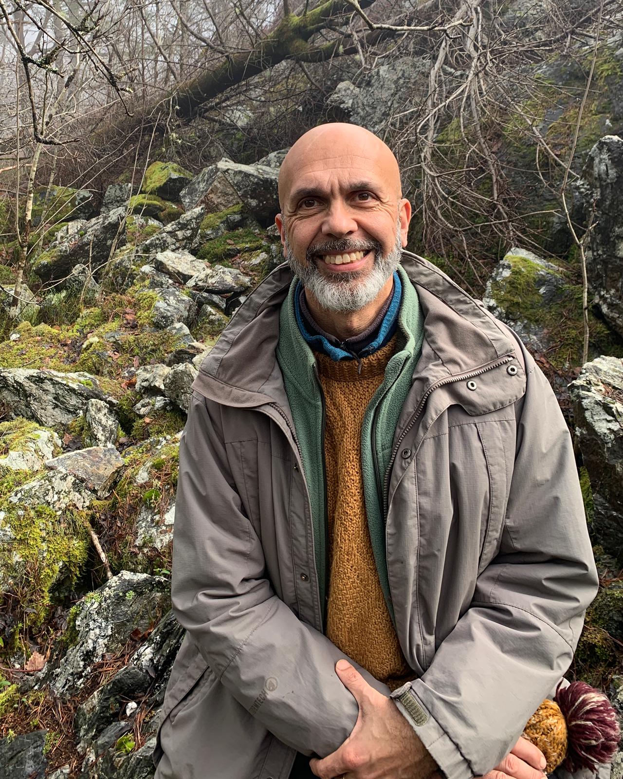 Rajni smiling in a woodland-inspired space